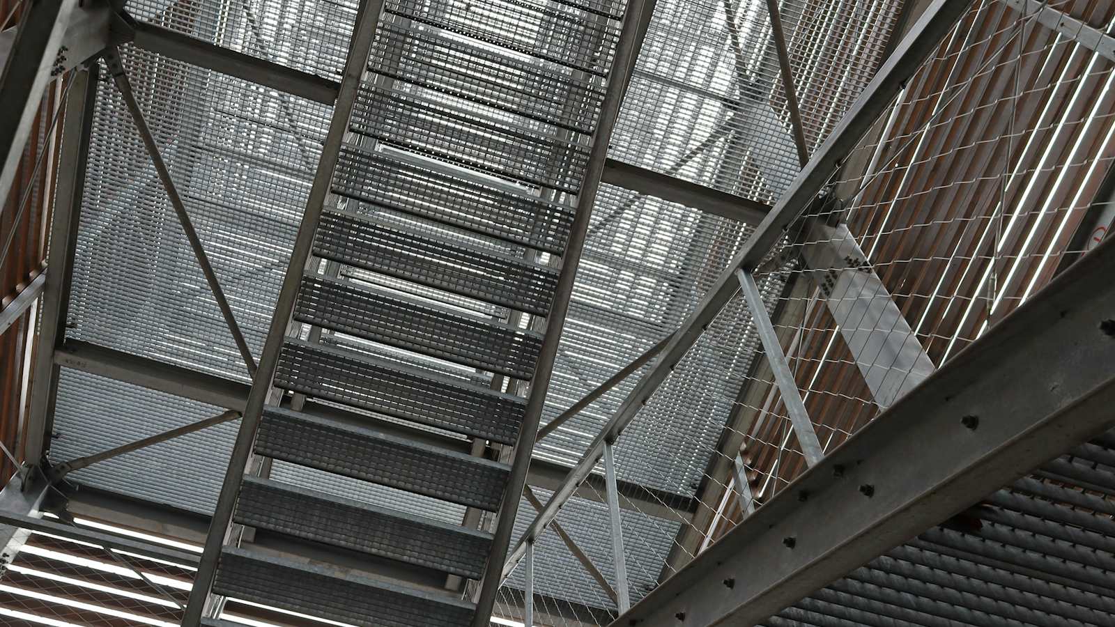 Wide upward view of a fabricated steel staircase and walkway structure