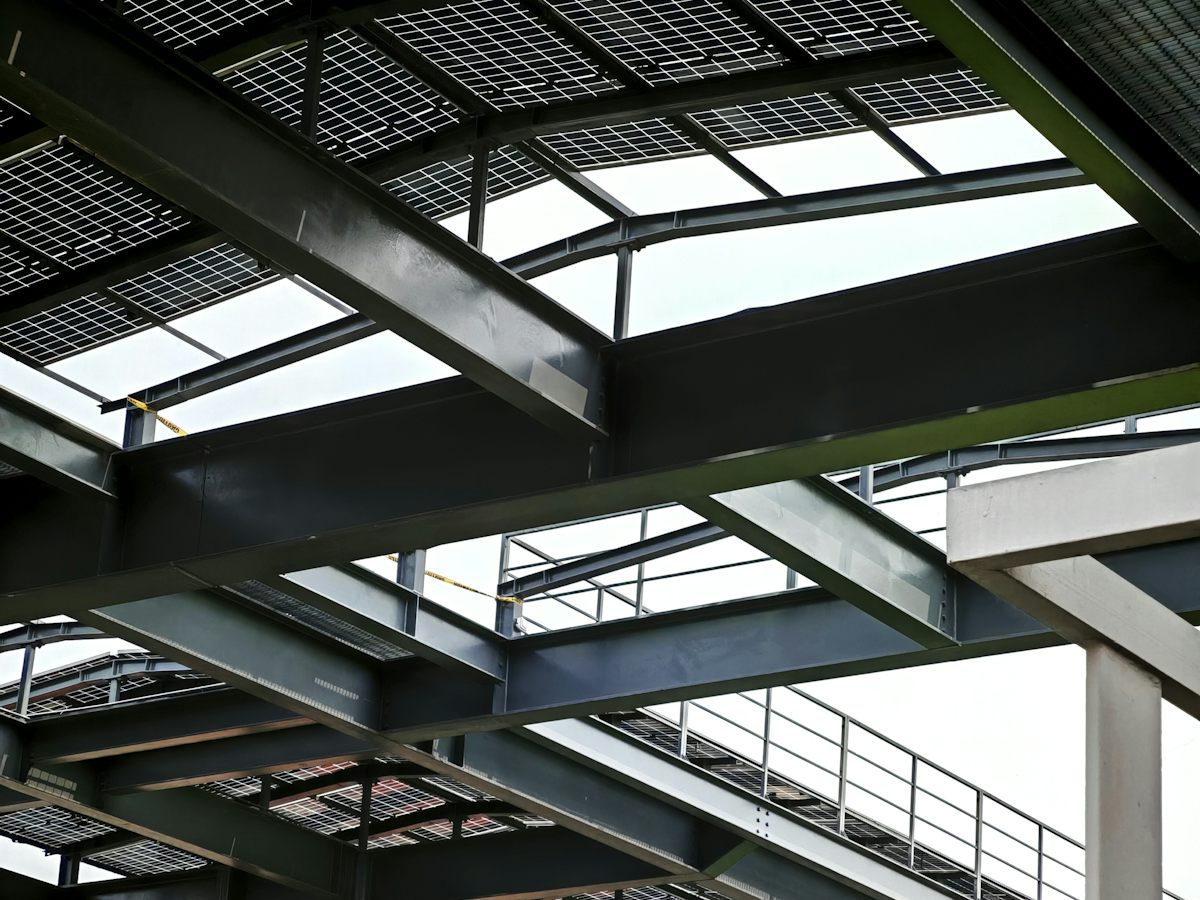 Interior view of steel beams and roofing in a fabricated building frame